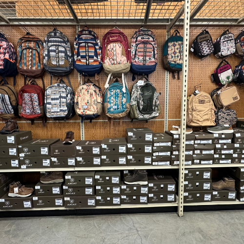 Clothes on display inside of McGregor General store, featuring shoes and backpacks.